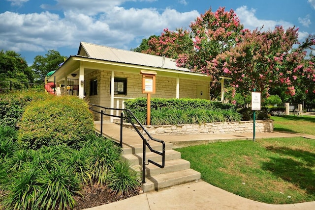 16202 Kicking Bird Dr, Leander, TX 78641 - view of front of home with a porch, a front yard, and metal roof