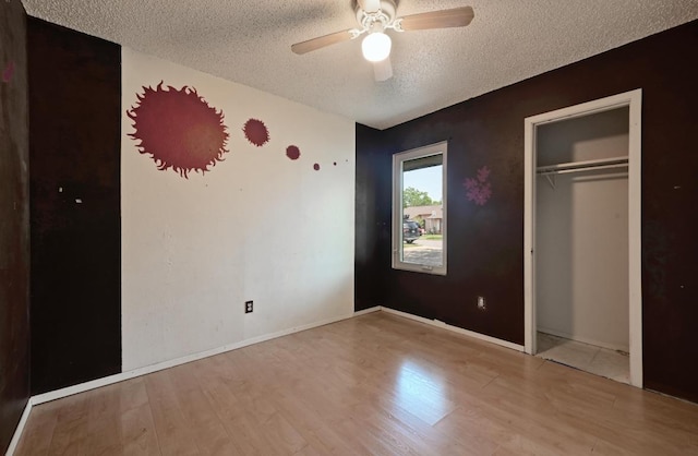 6212 Boxcar Run, Austin, TX 78745 - unfurnished bedroom with a textured ceiling, wood finished floors, a closet, a ceiling fan, and baseboards