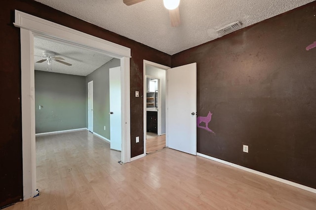 6212 Boxcar Run, Austin, TX 78745 - empty room featuring ceiling fan, a textured ceiling, wood finished floors, and baseboards