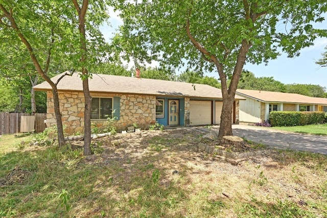 6212 Boxcar Run, Austin, TX 78745 - ranch-style home featuring stone siding, a garage, driveway, and a chimney