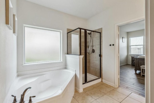 1084 Violet Ln, Kyle, TX 78640 - bathroom featuring a garden tub, a stall shower, and tile patterned flooring