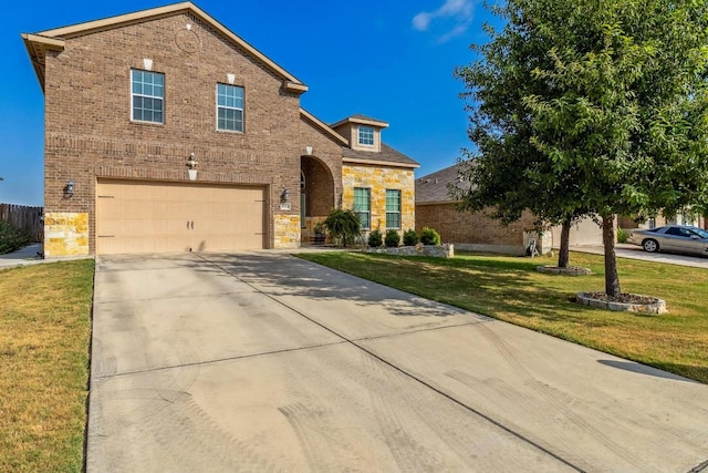 1084 Violet Ln, Kyle, TX 78640 - traditional-style home with brick siding, a garage, driveway, and a front yard