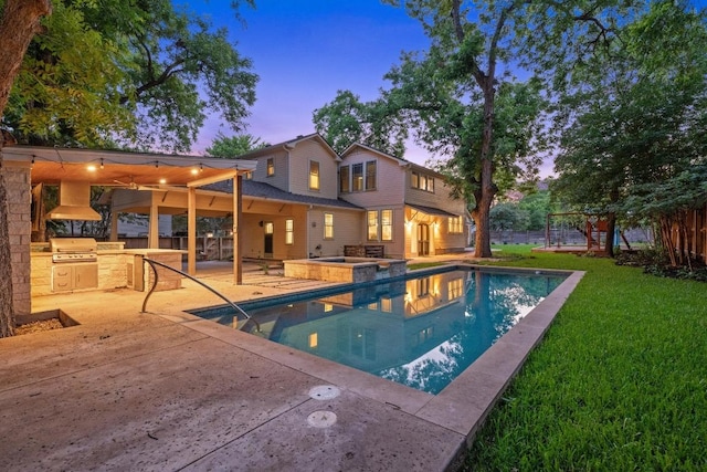 4517 Ave G, Austin, TX 78751 - view of pool featuring an outdoor kitchen, a patio, a yard, and a pool with connected hot tub