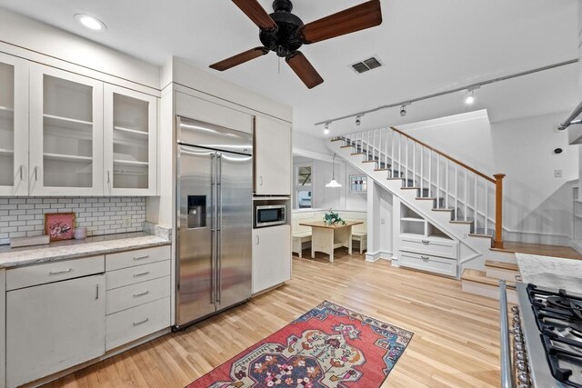 4517 Ave G, Austin, TX 78751 - kitchen with built in appliances, track lighting, a ceiling fan, light wood-style flooring, and recessed lighting