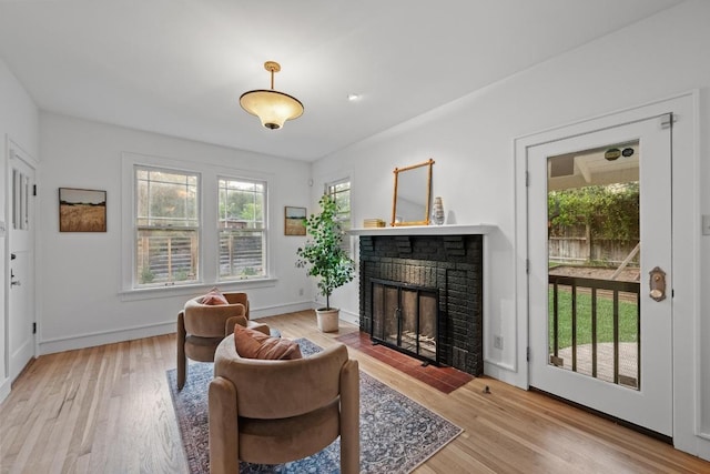 4517 Ave G, Austin, TX 78751 - living room with a brick fireplace and wood finished floors