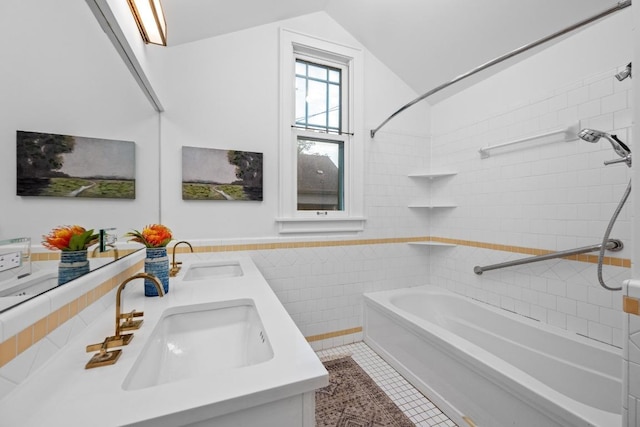 4517 Ave G, Austin, TX 78751 - bathroom featuring shower / bath combination, double vanity, tile walls, tile patterned floors, and vaulted ceiling