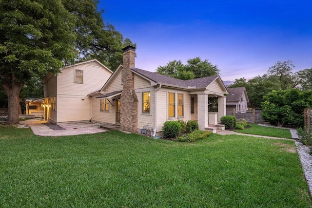 4517 Ave G, Austin, TX 78751 - view of front facade with a chimney, a patio area, and roof with shingles