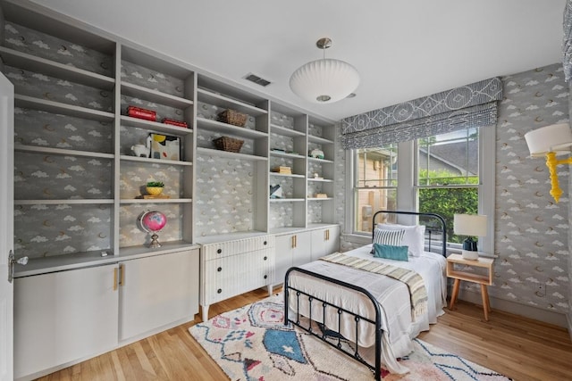 4517 Ave G, Austin, TX 78751 - bedroom featuring wallpapered walls and light wood-type flooring