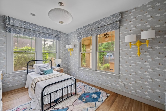 4517 Ave G, Austin, TX 78751 - bedroom with wallpapered walls and wood finished floors