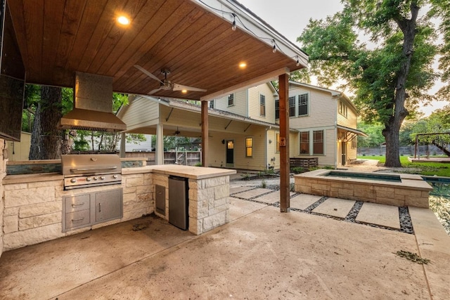 4517 Ave G, Austin, TX 78751 - view of patio with an outdoor kitchen, a ceiling fan, and an in-ground hot tub