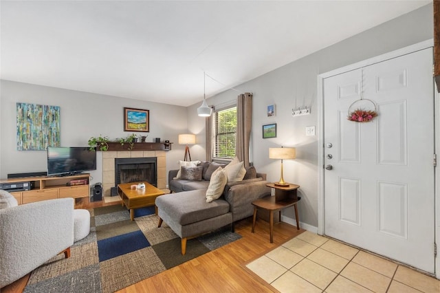 5616 Emerald Forest Dr Unit 111, Austin, TX 78745 - living area with light wood-style floors, a fireplace, and baseboards