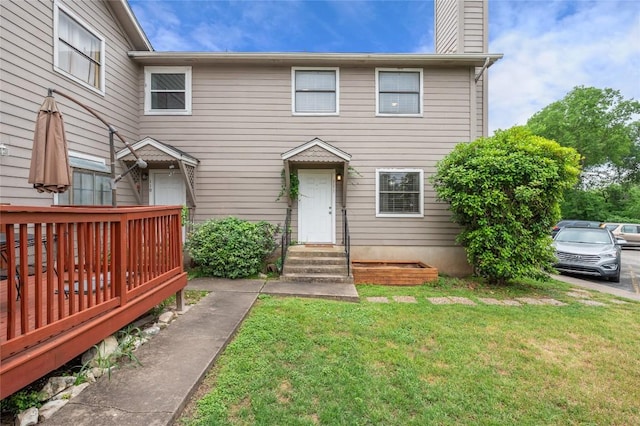 5616 Emerald Forest Dr Unit 111, Austin, TX 78745 - view of property featuring a front yard, a chimney, and a deck