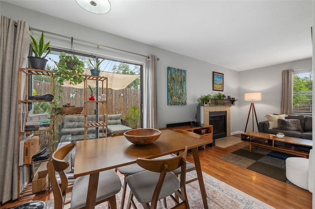 5616 Emerald Forest Dr Unit 111, Austin, TX 78745 - dining area with wood finished floors and a tile fireplace