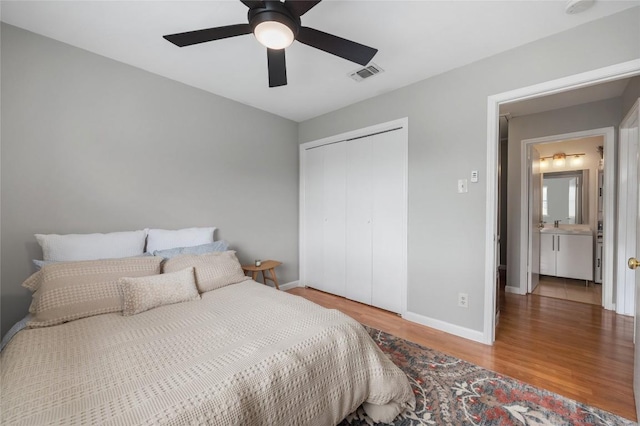 5616 Emerald Forest Dr Unit 111, Austin, TX 78745 - bedroom with wood finished floors, baseboards, a closet, and ceiling fan