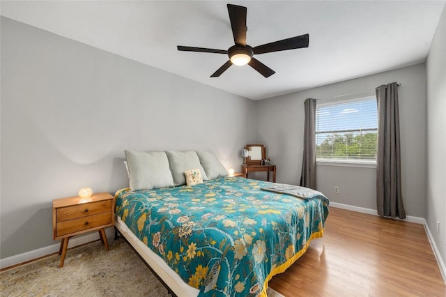 5616 Emerald Forest Dr Unit 111, Austin, TX 78745 - bedroom featuring wood finished floors, baseboards, and a ceiling fan