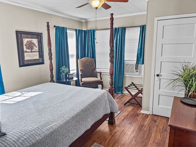 206 S Clear St, San Saba, TX 76877 - bedroom with ornamental molding, dark wood finished floors, cooling unit, and ceiling fan