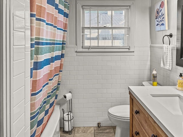 206 S Clear St, San Saba, TX 76877 - bathroom featuring tile walls, tile patterned flooring, toilet, vanity, and a shower with shower curtain