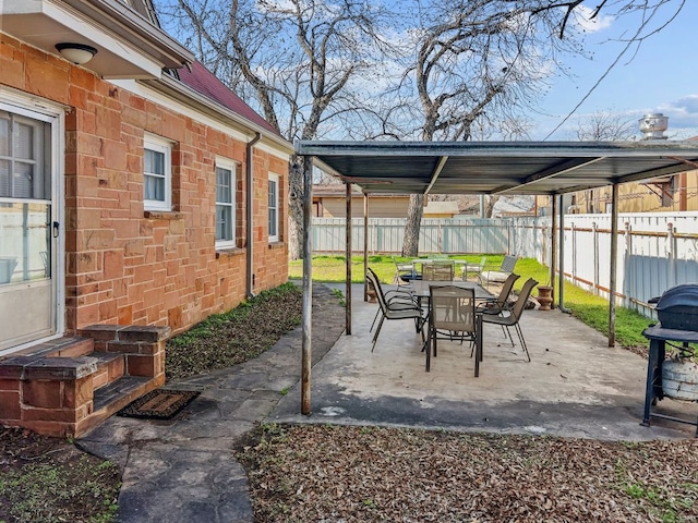 206 S Clear St, San Saba, TX 76877 - fenced backyard featuring outdoor dining space, a patio area, and a grill