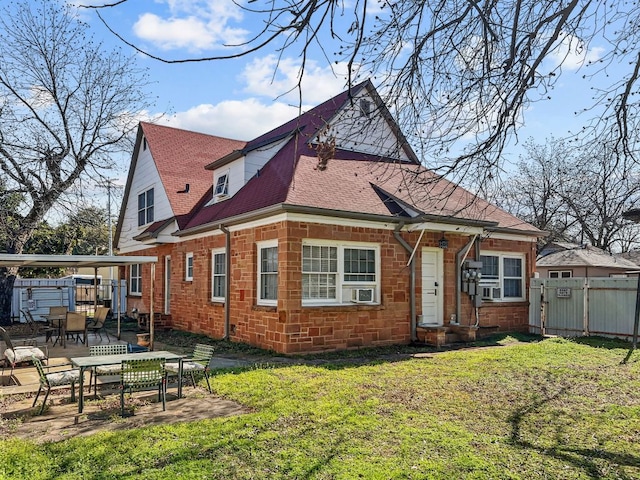 206 S Clear St, San Saba, TX 76877 - back of property with a patio area, a shingled roof, and outdoor dining area