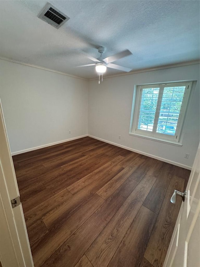 4424 Campo Verde Dr, Austin, TX 78749 - unfurnished room featuring dark wood-style flooring, ceiling fan, baseboards, a textured ceiling, and crown molding