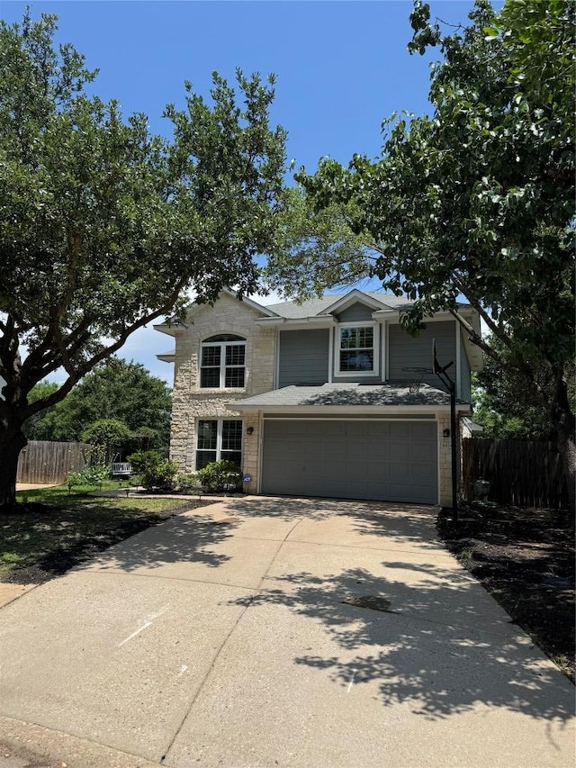 4424 Campo Verde Dr, Austin, TX 78749 - traditional-style house with stone siding, concrete driveway, and a garage