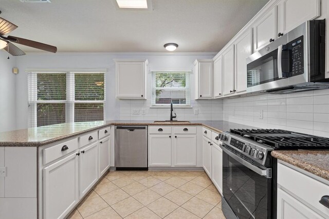 4424 Campo Verde Dr, Austin, TX 78749 - kitchen featuring stainless steel appliances, a sink, white cabinets, ceiling fan, and a peninsula