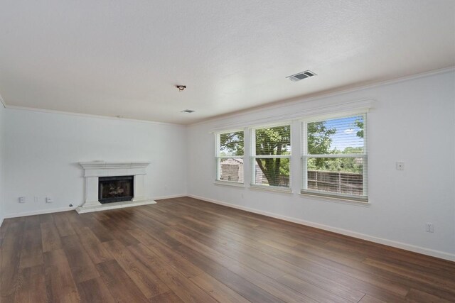 4424 Campo Verde Dr, Austin, TX 78749 - unfurnished living room with crown molding, baseboards, dark wood-style flooring, and a fireplace with raised hearth