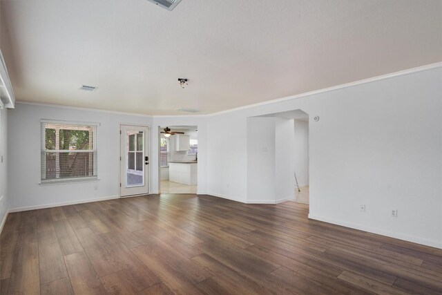 4424 Campo Verde Dr, Austin, TX 78749 - unfurnished living room featuring dark wood-style floors, baseboards, ceiling fan, and ornamental molding