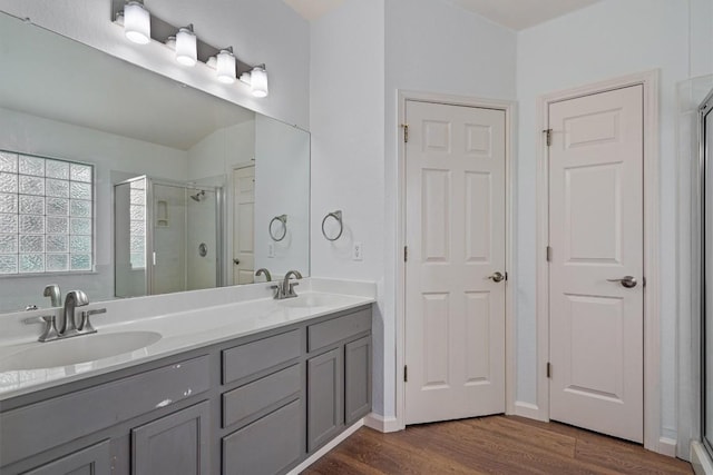 4424 Campo Verde Dr, Austin, TX 78749 - bathroom with wood finished floors, a stall shower, and double vanity