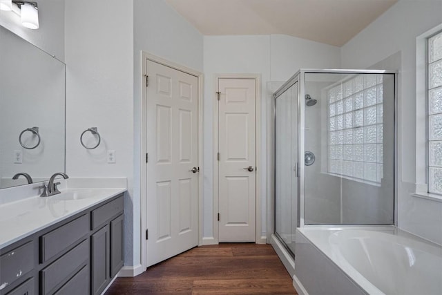 4424 Campo Verde Dr, Austin, TX 78749 - full bathroom with a stall shower, vanity, wood finished floors, and a garden tub
