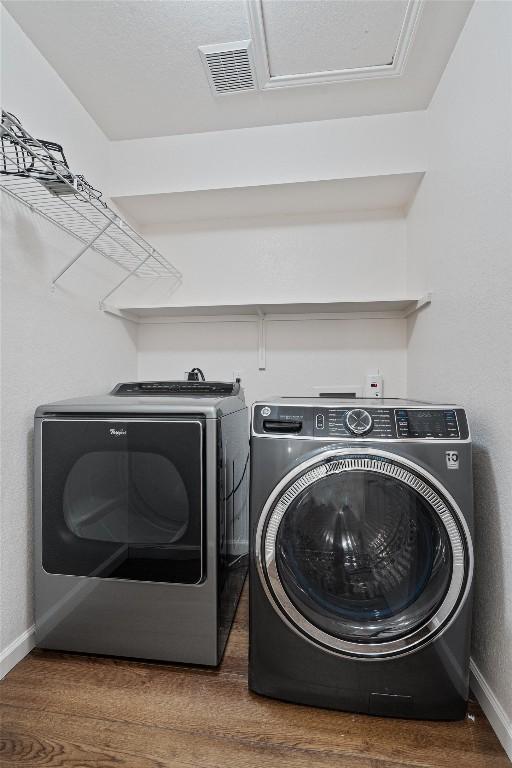 4424 Campo Verde Dr, Austin, TX 78749 - washroom featuring independent washer and dryer, baseboards, and wood finished floors
