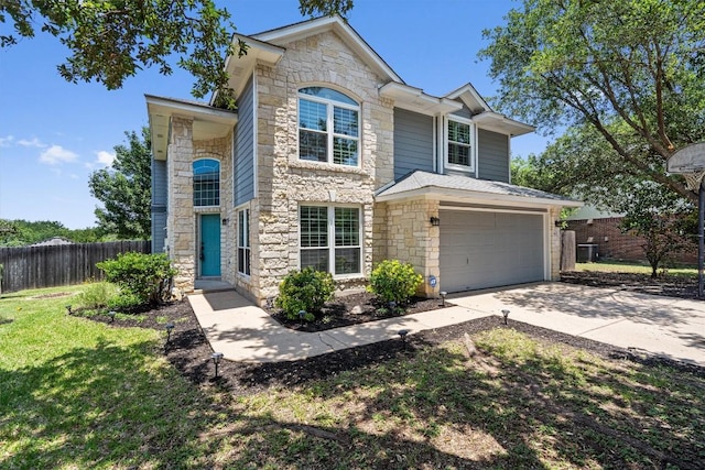 4424 Campo Verde Dr, Austin, TX 78749 - traditional home featuring stone siding, an attached garage, and driveway