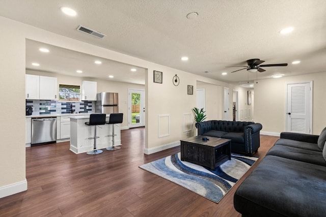 1145 E Sunset St, Waco, TX 76704 - living area with recessed lighting, baseboards, dark wood-style floors, a ceiling fan, and a textured ceiling
