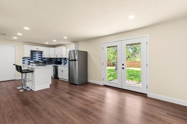 1145 E Sunset St, Waco, TX 76704 - kitchen with appliances with stainless steel finishes, french doors, light countertops, dark wood-style flooring, and recessed lighting