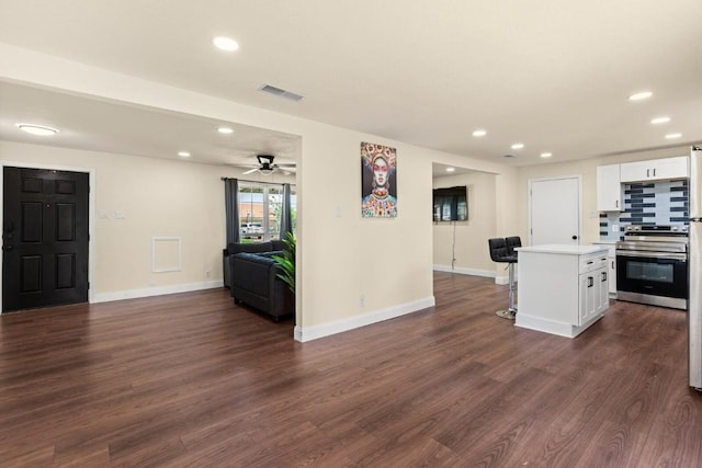 1145 E Sunset St, Waco, TX 76704 - kitchen with stainless steel electric stove, open floor plan, white cabinetry, recessed lighting, and dark wood-style flooring