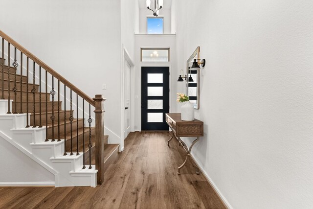 170 Fawn River Run, Kyle, TX 78640 - entrance foyer featuring wood finished floors, a towering ceiling, baseboards, and stairway