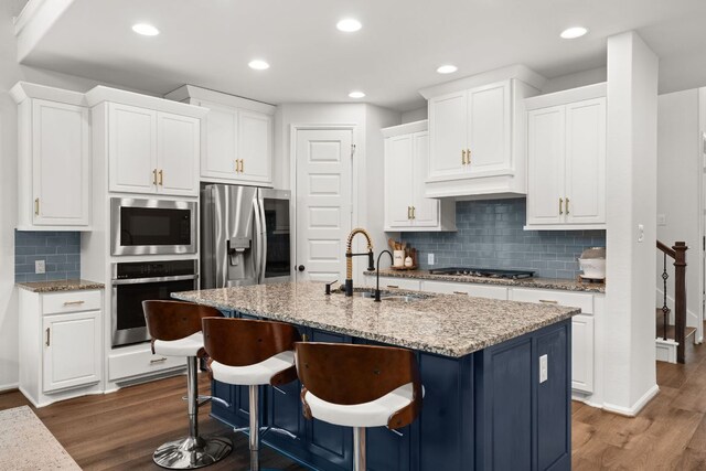 170 Fawn River Run, Kyle, TX 78640 - kitchen featuring appliances with stainless steel finishes, a sink, tasteful backsplash, white cabinetry, and recessed lighting