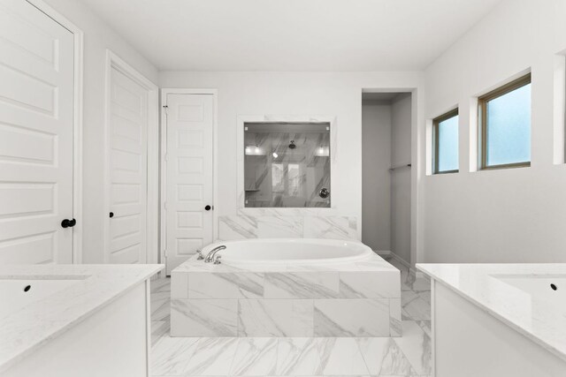 170 Fawn River Run, Kyle, TX 78640 - bathroom with vanity, a garden tub, and marble finish flooring