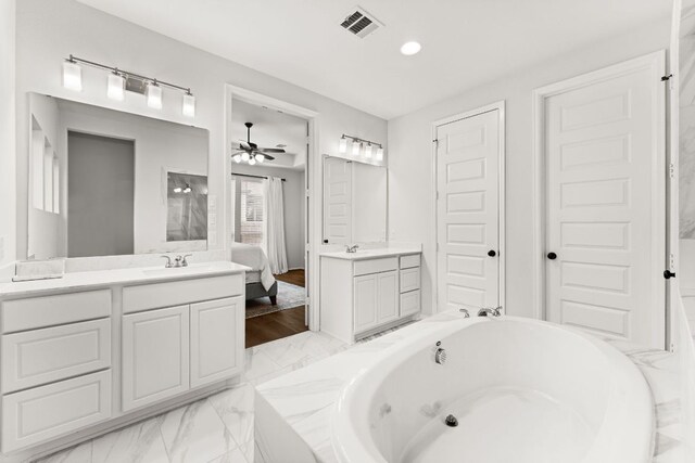 170 Fawn River Run, Kyle, TX 78640 - ensuite bathroom with vanity, a tub to relax in, a ceiling fan, and recessed lighting