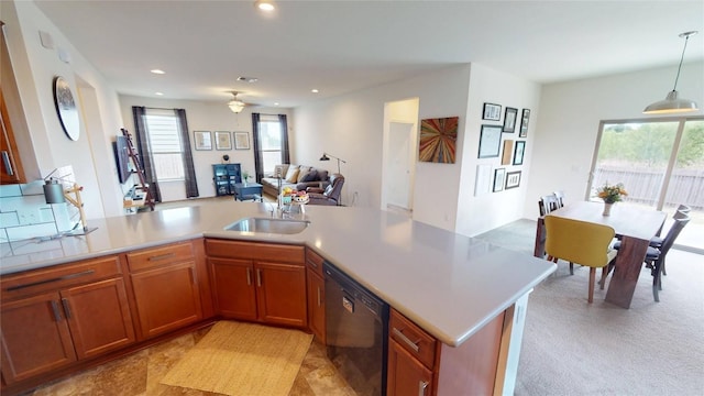 11405 Kirkland Hill Path, Austin, TX 78754 - kitchen featuring dishwasher, a sink, light countertops, open floor plan, and brown cabinetry