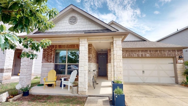 11405 Kirkland Hill Path, Austin, TX 78754 - view of front facade with covered porch, roof with shingles, brick siding, a garage, and driveway
