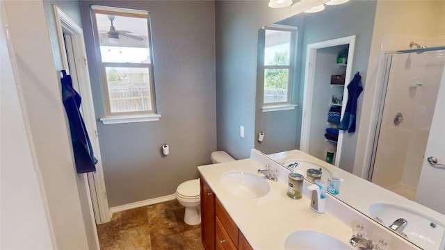 11405 Kirkland Hill Path, Austin, TX 78754 - bathroom with a stall shower, double vanity, toilet, ceiling fan, and baseboards