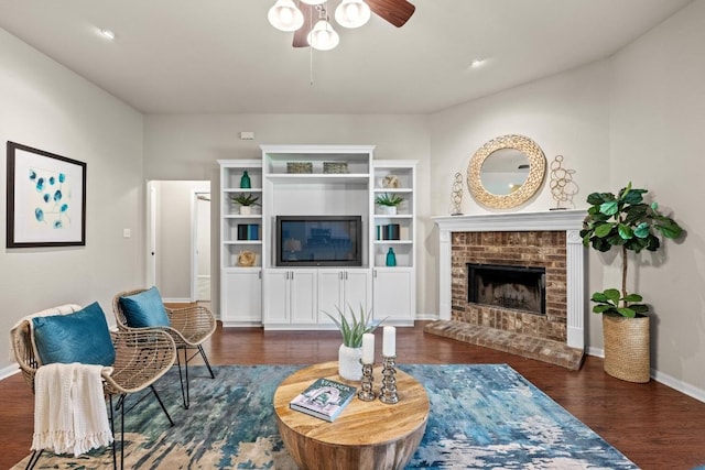 106 Guadalupe Dr, Hutto, TX 78634 - living room with ceiling fan, wood finished floors, baseboards, and a fireplace