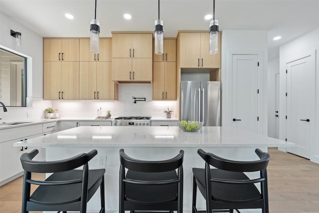 2303 Westworth Cir, Austin, TX 78704 - kitchen with freestanding refrigerator, light brown cabinetry, a sink, stove, and recessed lighting