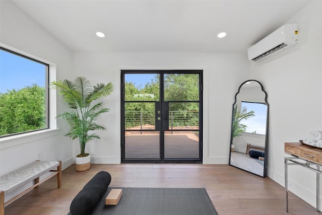 2303 Westworth Cir, Austin, TX 78704 - doorway with a wall mounted AC, wood finished floors, french doors, recessed lighting, and baseboards