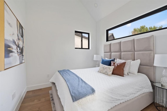 2303 Westworth Cir, Austin, TX 78704 - bedroom featuring vaulted ceiling, wood finished floors, and baseboards