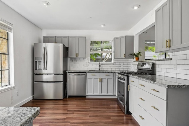 9906 Briar Ridge Dr, Austin, TX 78748 - kitchen featuring appliances with stainless steel finishes, gray cabinetry, decorative backsplash, and recessed lighting