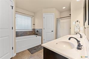 205 W Little Dipper Dr, Killeen, TX 76542 - bathroom featuring a bath, double vanity, and a shower with shower curtain