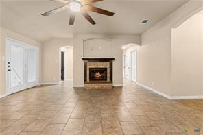 205 W Little Dipper Dr, Killeen, TX 76542 - unfurnished living room featuring arched walkways, stone tile floors, and baseboards