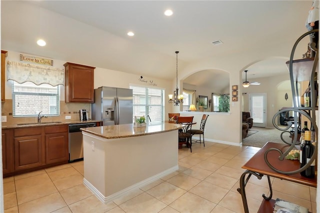 2002 S Ash Cv, Hutto, TX 78634 - kitchen featuring stainless steel appliances, a sink, light tile patterned floors, plenty of natural light, and recessed lighting